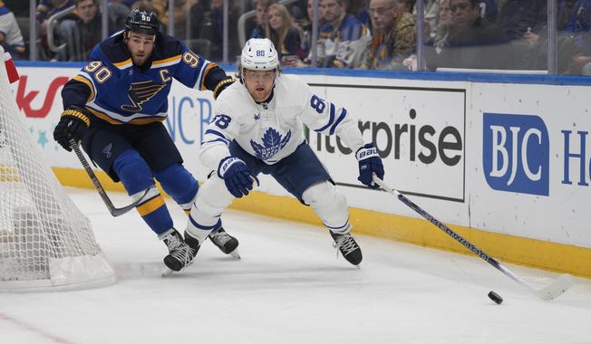 Toronto Maple Leafs&#x27; William Nylander (88) and St. Louis Blues&#x27; Ryan O&#x27;Reilly (90) chase after a loose puck during the first period of an NHL hockey game Tuesday, Dec. 27, 2022, in St. Louis. (AP Photo/Jeff Roberson)