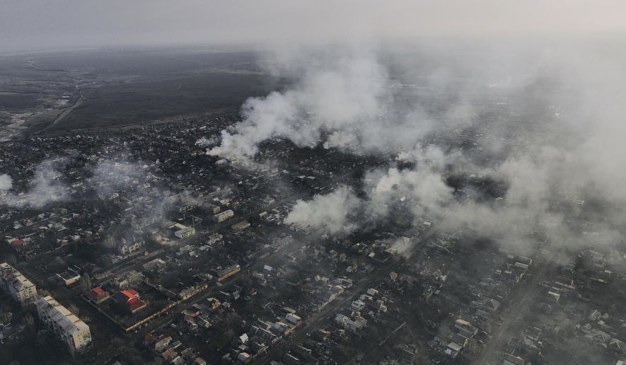 Smoke billows after Russian attacks in the outskirts of Bakhmut, Ukraine, Tuesday, Dec. 27, 2022. (AP Photo/Libkos)