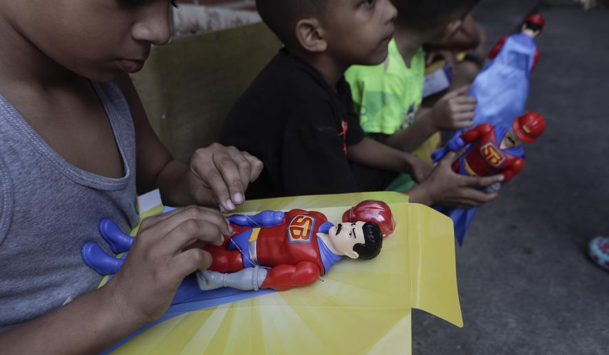 Children play with &quot;Super Bigote&quot; dolls in the Carayaca neighborhood of La Guaira , Venezuela, Tuesday, Dec. 27, 2022. The delivery of toys of &quot;Super Bigote&quot; or Super Mustache and &quot;Cilita&quot; dolls based on the image of Venezuelan President Nicolas Maduro and his wife Cilia Flores, were handed to thousands of children this Christmas, causing controversy among some Venezuelans. (AP Photo/Jesus Vargas)