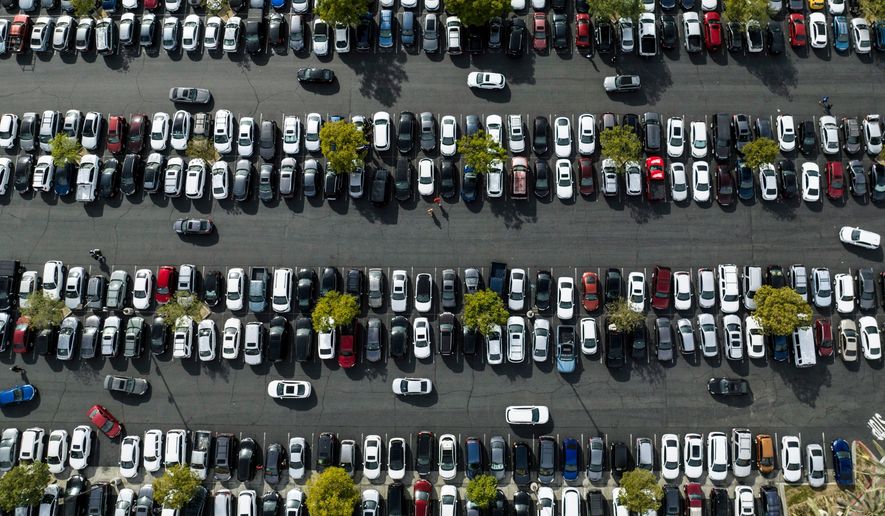 In this photo taken by a drone, motorists look for an open space to park in the parking lot of Citadel Outlets in Commerce, Calif., Monday, Nov. 21, 2022. (AP Photo/Jae C. Hong) **FILE**