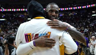 Los Angeles Lakers forward LeBron James, right, hugs Miami Heat forward Udonis Haslem after an NBA basketball game, Wednesday, Dec. 28, 2022, in Miami. The Heat won 112-98. (AP Photo/Lynne Sladky)