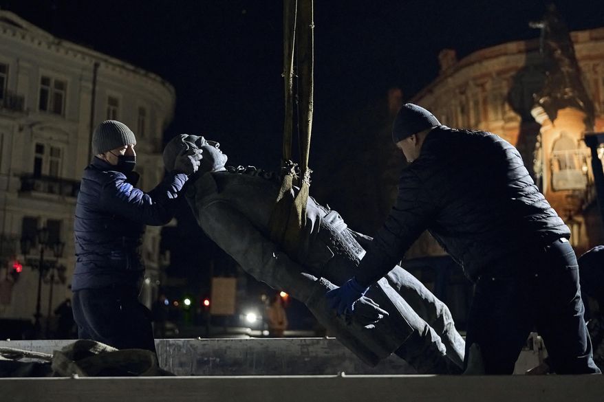 Workers remove part of the monument to Catherine II, also known as &quot;Monument to the Founders of Odesa&quot; in Odesa, Ukraine, late Wednesday, Dec. 28, 2022. The decision to dismantle the monument consisting of sculptures of Russian Empress Catherine II and her associates was made recently by Odesa residents by electronic voting. (AP Photo/LIBKOS)