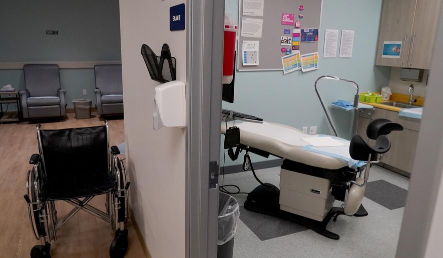 An unoccupied recovery area, left, and an abortion procedure room are seen at a Planned Parenthood Arizona facility in Tempe, Ariz., on June 30, 2022. On Friday, Dec. 30, 2022, the Arizona Court of Appeals concluded that abortion doctors can&#x27;t be prosecuted under a pre-statehood law that criminalizes nearly all abortions. The law had been blocked from being enforced shortly after the U.S. Supreme Court issued its 1973 Roe v. Wade decision. But after the Supreme Court overturned the landmark decision in June, Attorney General Mark Brnovich asked a state judge to allow the law to be implemented. (AP Photo/Matt York, File)