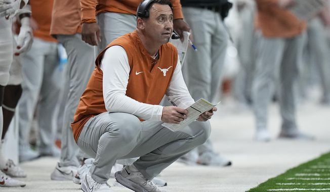 Texas head coach Steve Sarkisian watches from the sidelines during the first half of the Alamo Bowl NCAA college football game against the Washington in San Antonio, Thursday, Dec. 29, 2022. (AP Photo/Eric Gay)