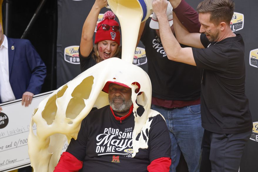 Maryland head coach Mike Locksley is doused with Duke's Mayo after Maryland defeated North Carolina State 16-12 in the Duke's Mayo Bowl NCAA college football game in Charlotte, N.C., Friday, Dec. 30, 2022. (AP Photo/Nell Redmond)