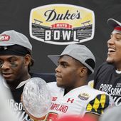 Maryland defensive back Jakorian Bennett, center, holds the trophy after Maryland defeated North Carolina State in the Duke&#x27;s Mayo Bowl NCAA college football game in Charlotte, N.C., Friday, Dec. 30, 2022. (AP Photo/Nell Redmond)