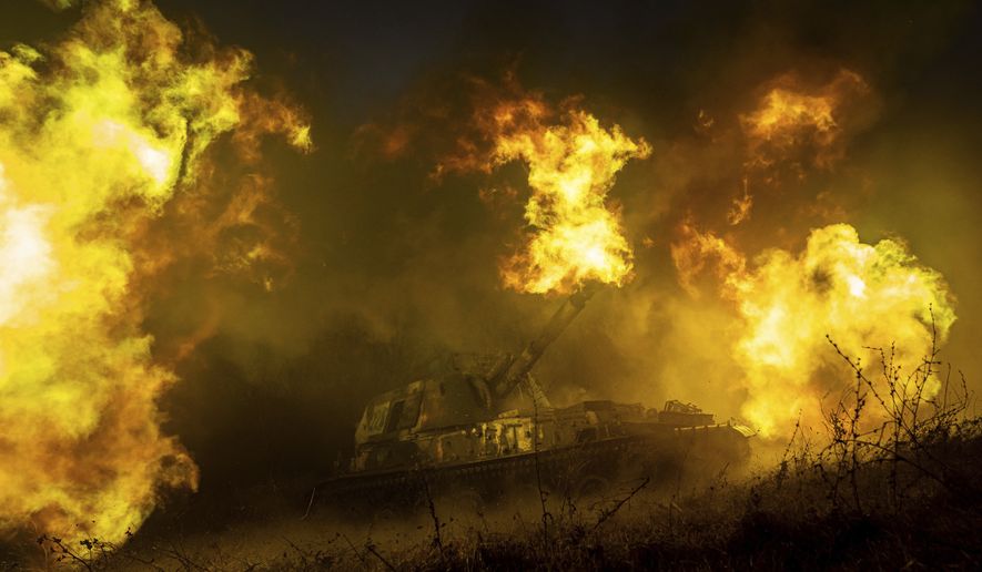 A Ukrainian self-propelled artillery shoots towards Russian forces at a frontline in Kharkiv region, Ukraine, Saturday, Dec. 24, 2022. (AP Photo/Evgeniy Maloletka)