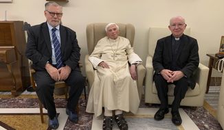 Pope Emeritus Benedict XVI, center, meets with the winners of the 2022 Ratzinger Prize, Joseph Halevi Horowitz Weiler, left, and father Michel Fedou, at the Mater Ecclesiae monastery inside the Vatican where Benedict XVI lives, in this photo taken Thursday, Dec. 1, 2022. (Fondazione Vaticana J.Ratzinger via AP)