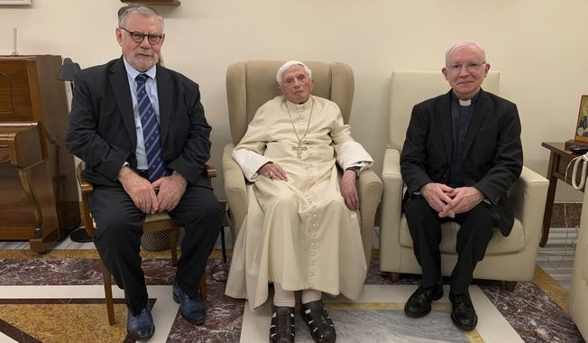 Pope Emeritus Benedict XVI, center, meets with the winners of the 2022 Ratzinger Prize, Joseph Halevi Horowitz Weiler, left, and father Michel Fedou, at the Mater Ecclesiae monastery inside the Vatican where Benedict XVI lives, in this photo taken Thursday, Dec. 1, 2022. (Fondazione Vaticana J.Ratzinger via AP)