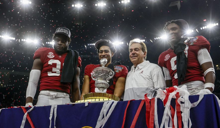 Alabama linebacker Will Anderson Jr., left, quarterback Bryce Young, center left, head coach Nick Saban, center right, and defensive back Jordan Battle, right, stand with the trophy as they celebrate after the Sugar Bowl NCAA college football game against Kansas State, Saturday, Dec. 31, 2022, in New Orleans. (AP Photo/Butch Dill) **FILE**