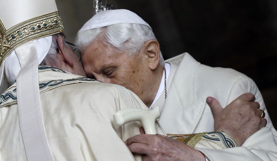 Pope Emeritus Benedict XVI, right, hugs Pope Francis in St. Peter&#x27;s Basilica during the ceremony marking the start of the Holy Year, at the Vatican, on Tuesday, Dec. 8, 2015. Pope Benedict XVIs 2013 resignation sparked calls for rules and regulations for future retired popes to avoid the kind of confusion that ensued. Benedict, the German theologian who will be remembered as the first pope in 600 years to resign, has died, the Vatican announced Saturday Dec. 31, 2022. He was 95. (AP Photo/Gregorio Borgia, File)