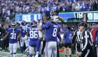 New York Giants&#39; Isaiah Hodgins (18) celebrates with quarterback Daniel Jones (8) after Jones rushed for a touchdown during the second half of an NFL football game against the Indianapolis Colts, Sunday, Jan. 1, 2023, in East Rutherford, N.J. (AP Photo/Seth Wenig)