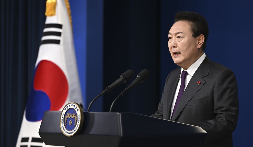 In this photo provided by South Korea Presidential Office, South Korean President Yoon Suk Yeol speaks during the New Year&#x27;s address to the nation at the presidential office in Seoul, South Korea, Sunday, Jan. 1, 2023. (South Korea Presidential Office via AP)