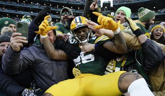 Green Bay Packers cornerback Keisean Nixon (25) celebrates with fans after returning a kickoff for a touchdown during the first half of an NFL football game against the Minnesota Vikings, Sunday, Jan. 1, 2023, in Green Bay, Wis. (AP Photo/Morry Gash)