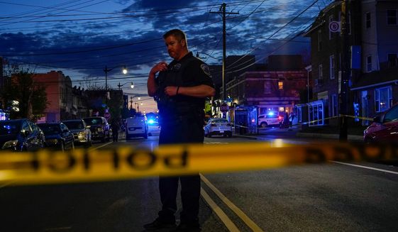 Police tape surrounds the scene after a second shooting Friday, April 22, 2022, injured three people in northwest Washington, a short distance away from another shooting that occurred earlier in the afternoon. (AP Photo/Jacquelyn Martin) ** FILE **