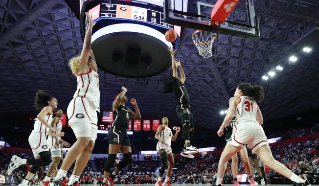 South Carolina guard Zia Cooke, second from right, shoots over Georgia guard Audrey Warren, right, during the second half of an NCAA college basketball game in Athens, Ga., Monday, Jan. 2, 2023. (AP Photo/Alex Slitz)