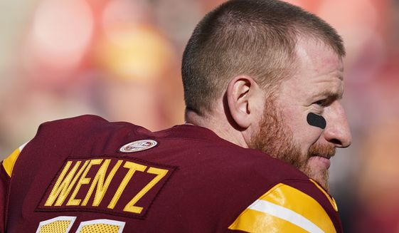 Washington Commanders quarterback Carson Wentz warms up before an NFL football game against the Cleveland Browns, Sunday, Jan. 1, 2023, in Landover, Md. (AP Photo/Patrick Semansky)