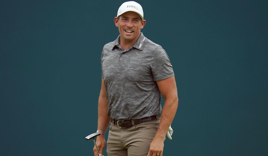 Scott Stallings reacts to a shot by Adam Scott, of Australia, on the 18th green during the final round of the BMW Championship golf tournament at Wilmington Country Club, Sunday, Aug. 21, 2022, in Wilmington, Del. (AP Photo/Julio Cortez, File)