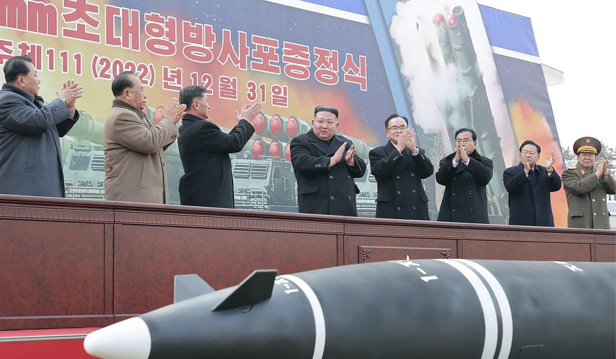 In this photo provided by the North Korean government, North Korean leader Kim Jong-un, center, attends a ceremony of donating 600 mm super-large multiple launch rocket system at a garden of the Workers&#x27; Party of Korea headquarters in Pyongyang, North Korea Saturday, Dec. 31, 2022. Independent journalists were not given access to cover the event depicted in this image distributed by the North Korean government. The content of this image is as provided and cannot be independently verified. Korean language watermark on image as provided by source reads: &quot;KCNA&quot; which is the abbreviation for Korean Central News Agency. (Korean Central News Agency/Korea News Service via AP)