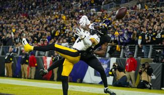 Baltimore Ravens cornerback Brandon Stephens (21) breaks up a pass to Pittsburgh Steelers wide receiver George Pickens (14) in the first half of an NFL football game in Baltimore, Sunday, Jan. 1, 2023. (AP Photo/Julio Cortez)