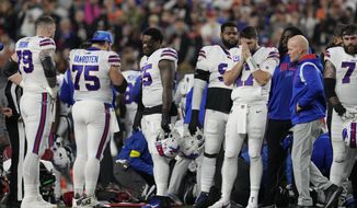 Buffalo Bills quarterback Josh Allen (17) pauses as Damar Hamlin is examined during the first half of an NFL football game against the Cincinnati Bengals, Monday, Jan. 2, 2023, in Cincinnati. (AP Photo/Jeff Dean)