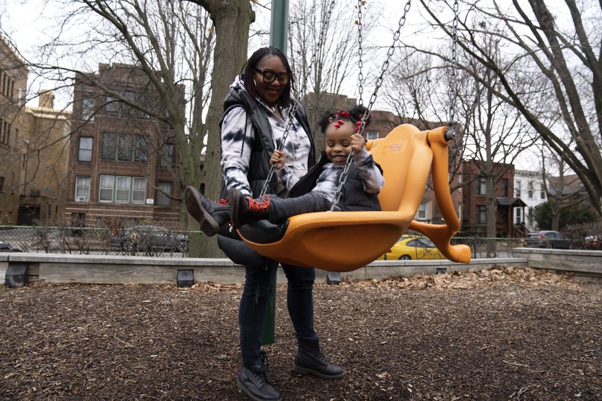 Chicago educator Tamisha Holifield spends time with her 2-year-old daughter Rian Holifield at Nichols Park, Thursday, Dec. 29, 2022, in the Hyde Park neighborhood of Chicago. When Holifield and her daughter had COVID-19 in May, the toddler had to miss 15 days of child care. Bouts of colds have followed in what Holifield described as a &quot;constant whirlwind&quot; of sickness that has been stressful both financially and emotionally. &quot;It&#x27;s a major inconvenience. But I&#x27;m a single parent, so I don&#x27;t have a choice. If I drop the ball, the game is over,&quot; Holifield said. (AP Photo/Erin Hooley)