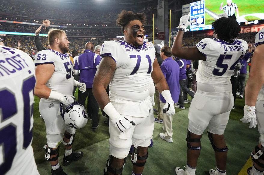 TCU offensive tackle Marcus Williams (71) celebrates with teammates after the Fiesta Bowl NCAA college football semifinal playoff game against Michigan, Saturday, Dec. 31, 2022, in Glendale, Ariz. TCU defeated Michigan 51-45. (AP Photo/Ross D. Franklin) **FILE**