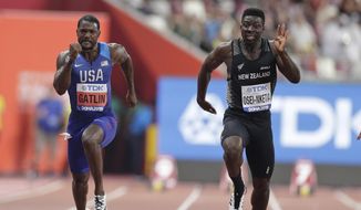New Zealand&#39;s Edward Osei-Nketia, right, and Justin Gatlin of the United States compete during the men&#39;s 100 meters heat at the World Athletics Championships in Doha, Qatar, Sept. 27, 2019. The fastest man in New Zealand is ready to try college football. Eddie Osei-Nketia holds his country&#39;s 100-meter record and has some rugby experience. He has signed to play for Hawaii and is among a geographically diverse group of international recruits who will suit up on campuses across the United States. (AP Photo/Petr David Josek, File) **FILE**