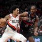 Portland Trail Blazers guard Anfernee Simons, left, drives to the basket on Detroit Pistons guard Alec Burks during the first half of an NBA basketball game in Portland, Ore., Monday, Jan. 2, 2023. (AP Photo/Steve Dykes)