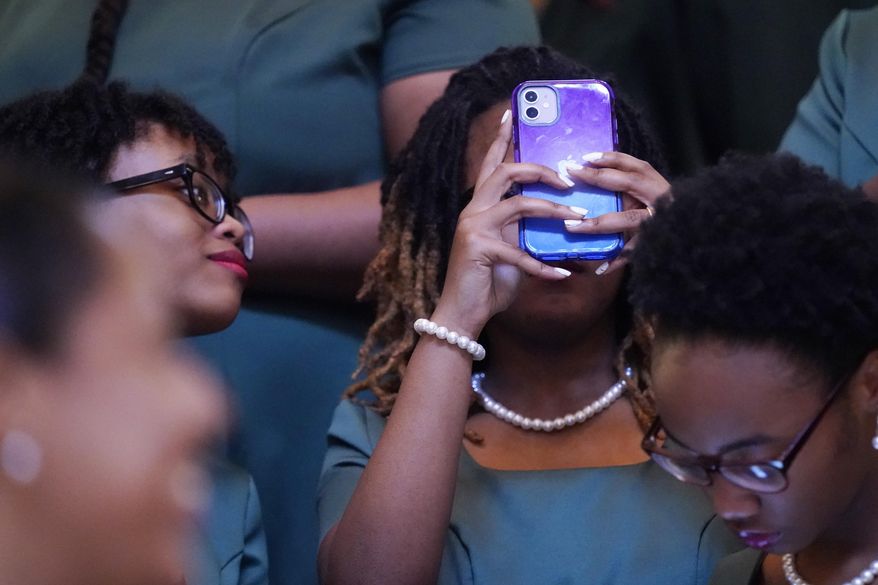 A member of the Jim Hill High School Choir uses her cellphone to photograph the rotunda of the Mississippi Capitol in Jackson, following an early morning performance prior to the start of the 2023 legislative session, Tuesday, Jan. 3, 2023. (AP Photo/Rogelio V. Solis)