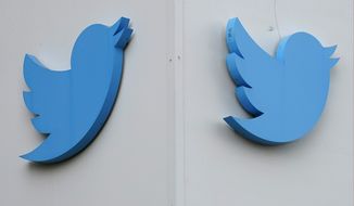Twitter logos are displayed outside the company&#39;s offices in San Francisco on Dec. 19, 2022. Elon Musk is trying to slash expenses at Twitter as close to zero as possible while his personal wealth shrinks — and this apparently has included falling behind on rent payments at the company&#39;s offices, according to a lawsuit filed by the landlord in December 2022. (AP Photo/Jeff Chiu, File)