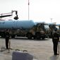 Chinese military vehicles carrying JL-2 submarine-launched missiles roll during a parade to commemorate the 70th anniversary of the founding of Communist China in Beijing, Tuesday, Oct. 1, 2019. Trucks carrying weapons including a nuclear-armed missile designed to evade U.S. defenses rumbled through Beijing as the Communist Party celebrated its 70th anniversary in power with a parade Tuesday that showcased China&#39;s ambition as a rising global force. (AP Photo/Mark Schiefelbein)