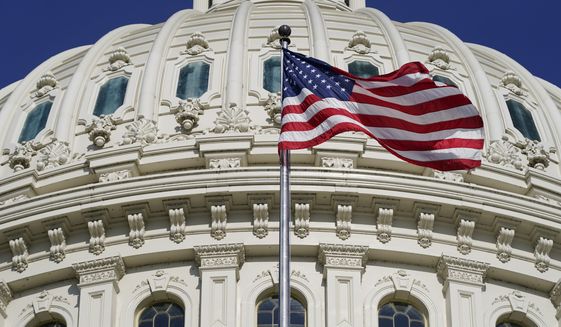 An American flag waves below the U.S. Capitol dome on Capitol Hill in Washington, Thursday, June 9, 2022. (AP Photo/Patrick Semansky)