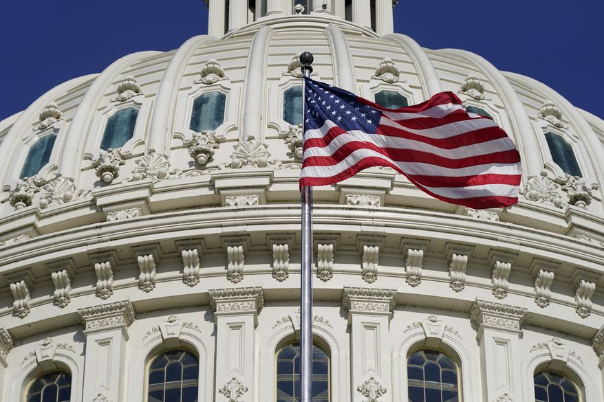 An American flag waves below the U.S. Capitol dome on Capitol Hill in Washington, Thursday, June 9, 2022. (AP Photo/Patrick Semansky)