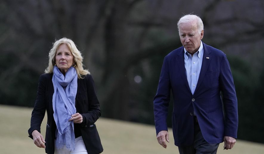 President Joe Biden and first lady Jill Biden walk on the South Lawn of the White House after stepping off Marine One, Monday, Jan. 2, 2023, in Washington. Jill Biden will undergo a medical procedure next week to remove a small lesion from above her right eye that was discovered during a routine skin cancer screening, the White House announced Wednesday. (AP Photo/Patrick Semansky, File)