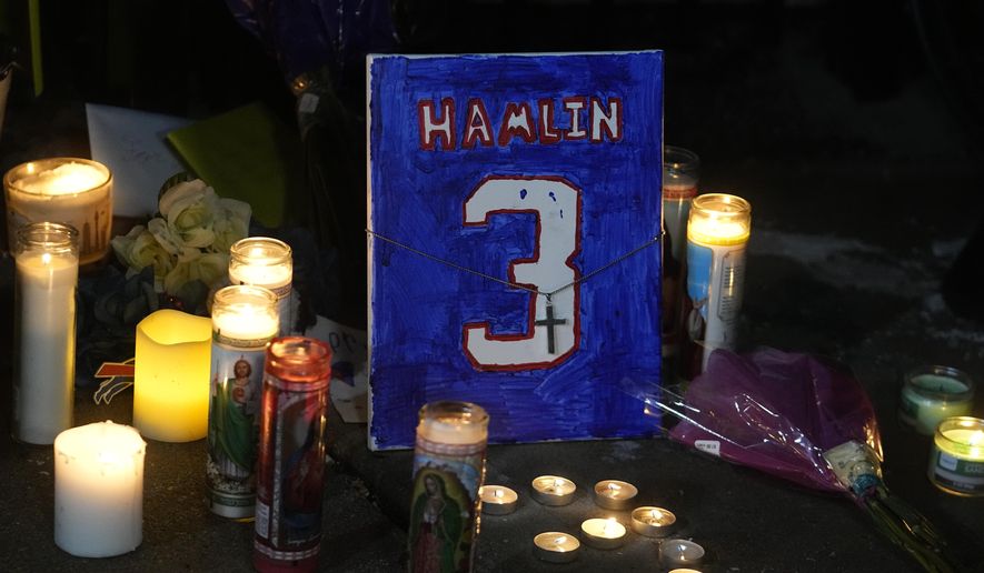 A painting that shows the number of Buffalo Bills&#x27; Damar Hamlin is illuminated by candles during a prayer vigil outside University of Cincinnati Medical Center, Tuesday, Jan. 3, 2023, in Cincinnati. Hamlin was taken to the hospital after collapsing on the field during an NFL football game against the Cincinnati Bengals on Monday night. (AP Photo/Darron Cummings) **FILE**