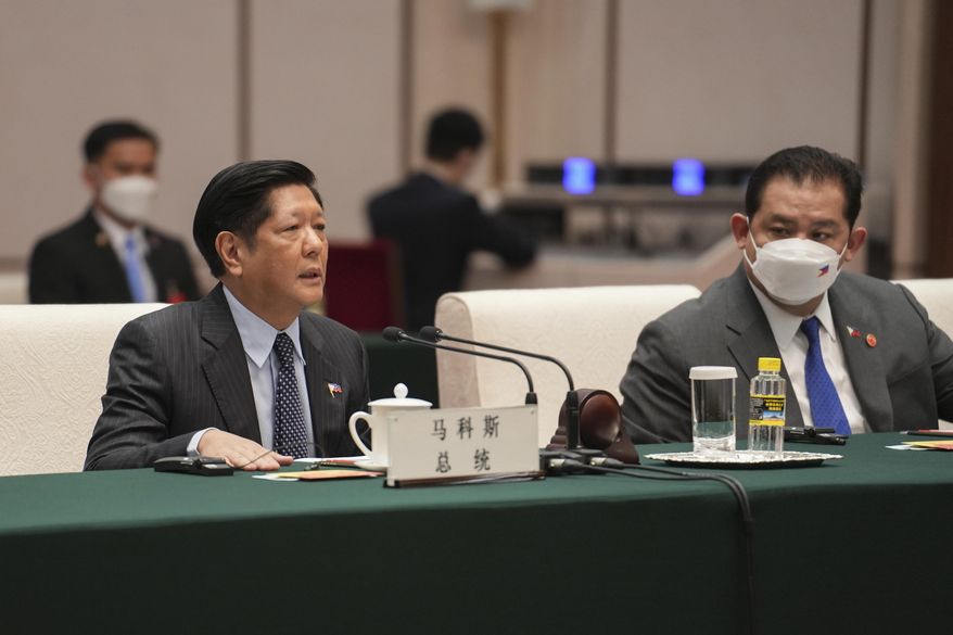 In this handout photo provided by the Malacanang Presidential Photographers Division, Philippine President Ferdinand Marcos Jr., left, speaks during his meeting with China&#x27;s Chairman of the Standing Committee of the National People&#x27;s Congress Li Zhanshu, not shown, at the Great Hall of the People, in Beijing, China, Wednesday Jan. 4, 2023. (Malacanang Presidential Photographers Division via AP)