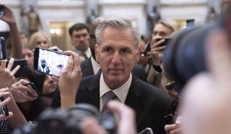 Rep. Kevin McCarthy, R-Calif., is surrounded by reporters as he walks to the House floor from the Speakers Office, Wednesday, Jan. 4, 2023, on Capitol Hill in Washington. (AP Photo/Jacquelyn Martin)