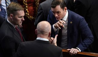 Rep. Mike Gallagher, R-Wis., right, talks with Rep. Chip Roy, R-Texas, in the House chamber as the House meets for a second day to elect a speaker and convene the 118th Congress in Washington, Wednesday, Jan. 4, 2023. (AP Photo/Andrew Harnik)