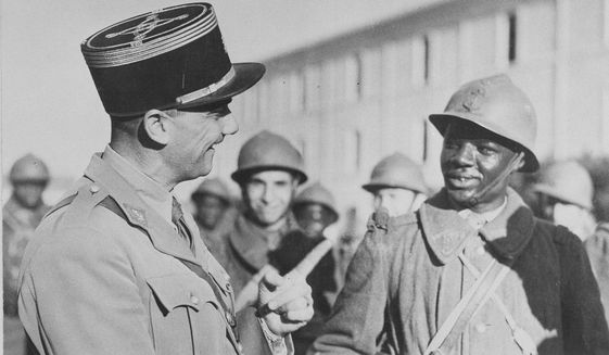 A French officer speaks to a Senegalese French Colonial soldier who has joined the Allies in North Africa under Gen. Henri Giraub on Dec. 28, 1942. Some of the last survivors in France from a colonial-era infantry corps that recruited tens of thousands of African soldiers to fight in French wars around the world will be able to live out their final days with family members back in Africa after a French government U-turn on their pension rights. (AP Photo, File)