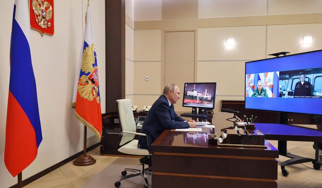Russian President Vladimir Putin attends a videoconference with Russian Defense Minister Sergei Shoigu, left, on a tv screen, and Igor Krokhmal, commander of the frigate named &quot;Admiral of the Fleet of the Soviet Union Gorshkov&quot;, right on a tv screen, in Moscow, Russia, Wednesday, Jan. 4, 2023. Putin on Wednesday sent a frigate off to the Atlantic Ocean armed with hypersonic Zircon cruise missiles. (Mikhail Klimentyev, Sputnik, Kremlin Pool Photo via AP)
