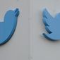 Twitter logos hang outside the company&#x27;s offices in San Francisco, Monday, Dec. 19, 2022. (AP Photo/Jeff Chiu)