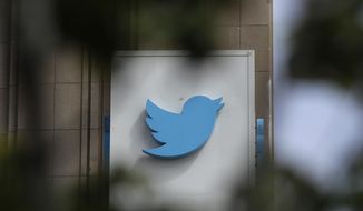 This July 9, 2019, file photo shows a sign outside of the Twitter office building in San Francisco. Twitter said late Tuesday, Jan. 3, 2023, that it will ease up on its 3-year-old ban on political advertising, the latest change by Elon Musk as he tries to pump up revenue after purchasing the social media platform last year. (AP Photo/Jeff Chiu, File)