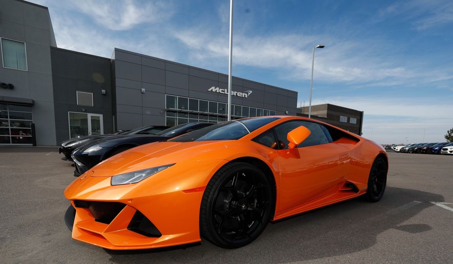 In this Sunday, March 15, 2020, photo, an unsold 2020 Huracan Evo sports car sits at a Lamborghini dealership in Englewood, Littleton, Highlands Ranch, Colo. (AP Photo/David Zalubowski) **FILE**