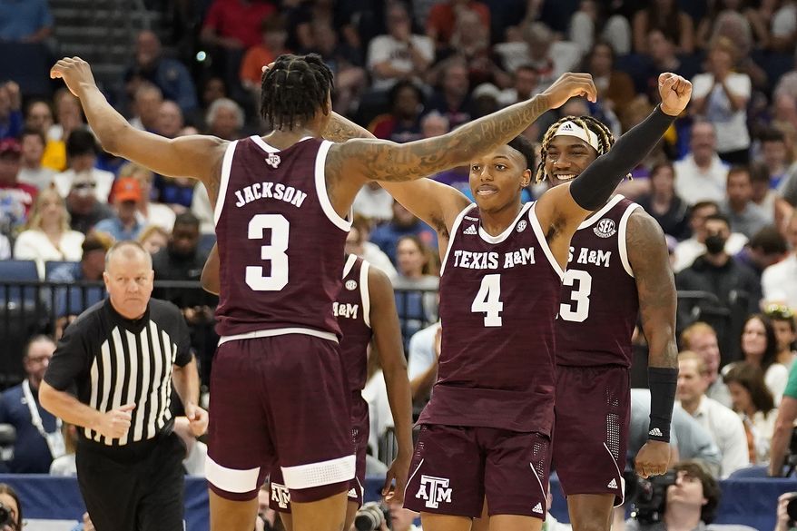 Texas A&amp;M guard Wade Taylor IV (4) celebrates with guard Quenton Jackson (3) after the team defeated Auburn during an NCAA men&#x27;s college basketball Southeastern Conference tournament game Friday, March 11, 2022, in Tampa, Fla. (AP Photo/Chris O&#x27;Meara) **FILE**