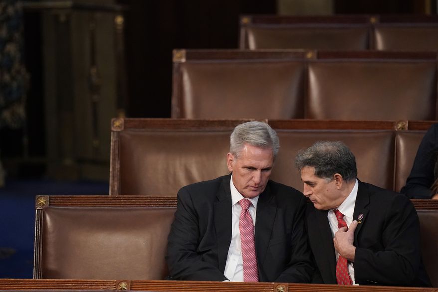 Rep. Kevin McCarthy, R-Calif., left, talks with Rep. Andrew Clyde, R-Ga., after a failed seventh vote in the House chamber as the House meets for the third day to elect a speaker and convene the 118th Congress in Washington, Thursday, Jan. 5, 2023. (AP Photo/Alex Brandon)