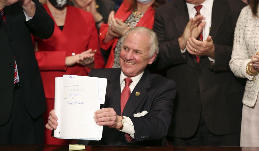 South Carolina Gov. Henry McMaster holds up a bill banning almost all abortions in the state after he signed it into law on Feb. 18, 2021, in Columbia, S.C. The South Carolina ban on abortions after cardiac activity is no more after the latest legal challenge to the state’s 2021 law proved successful. The state Supreme Court ruled Thursday, Jan. 5, 2023, that the restrictions violate the state constitution’s right to privacy. (AP Photo/Jeffrey Collins, File)