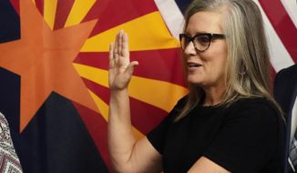 The new Arizona Democratic Gov. Katie Hobbs takes the oath of office in a ceremony at the state Capitol in Phoenix, Monday, Jan. 2, 2023. (AP Photo/Ross D. Franklin, Pool)