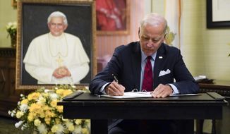 President Joe Biden signs a condolence book at the Apostolic Nunciature of the Holy See in Washington, Thursday, Jan. 5, 2023, for Pope Emeritus Benedict XVI. Benedict died at 95 on Dec. 31, 2022, in the monastery on the Vatican grounds where he had spent nearly all of his decade in retirement. (AP Photo/Patrick Semansky)