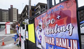 A sign sits along a fence outside UC Medical Center where Buffalo Bills safety Damar Hamiln remains hospitalized, Thursday, Jan. 5, 2023, in Cincinnati. Damar Hamlin has shown what physicians treating him are calling “remarkable improvement over the past 24 hours,” the team announced in a statement on Thursday, three days after the player went into cardiac arrest and had to be resuscitated on the field. (AP Photo/Joshua A. Bickel)